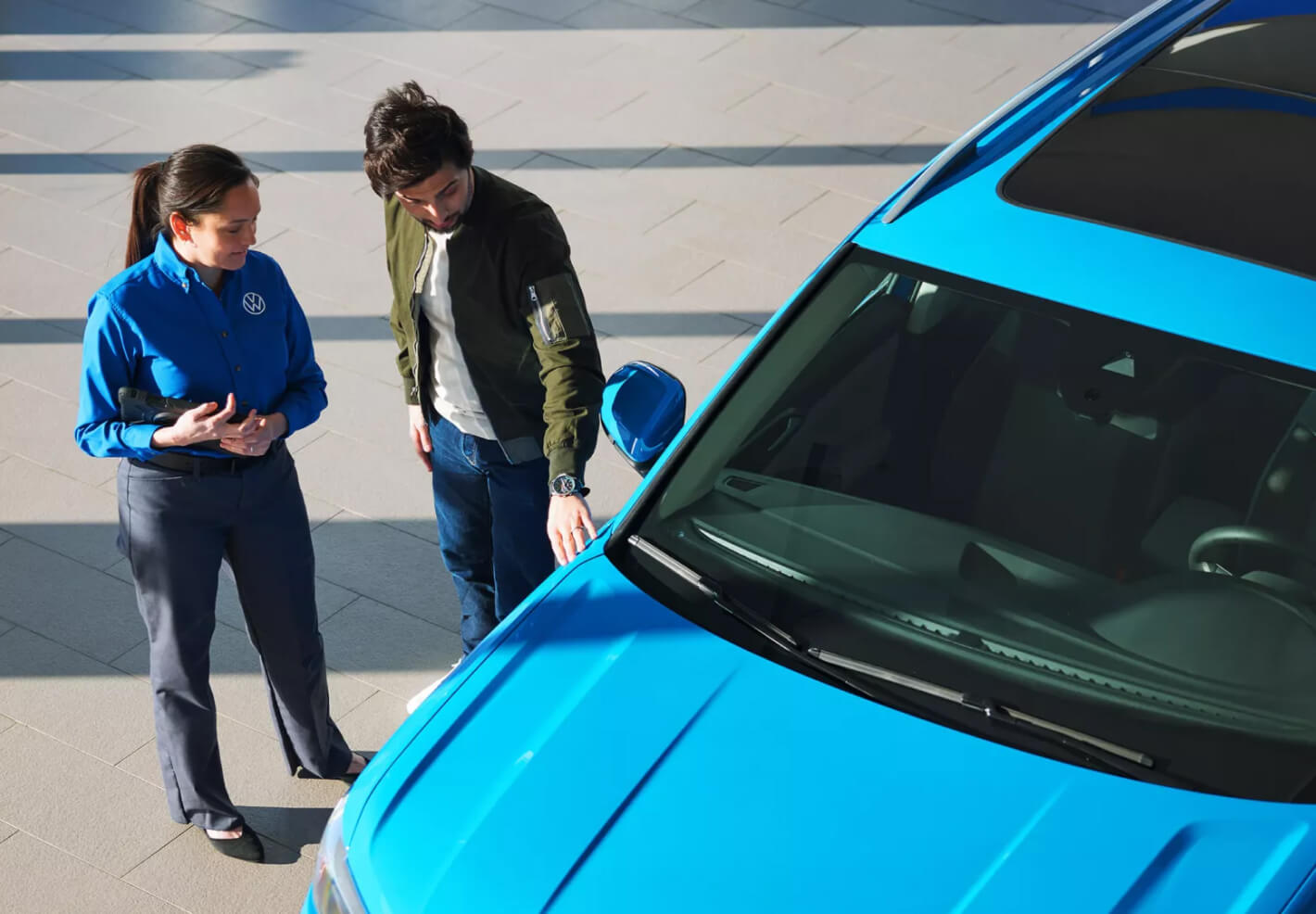Volkswagen automotive sales consultant speaking with customer